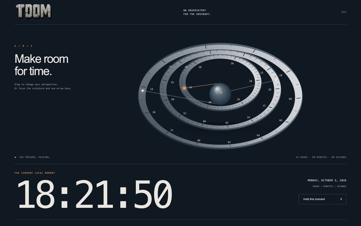 Three tilted rings for hours, minutes and seconds around a small sphere, above a large readout of the current local time.